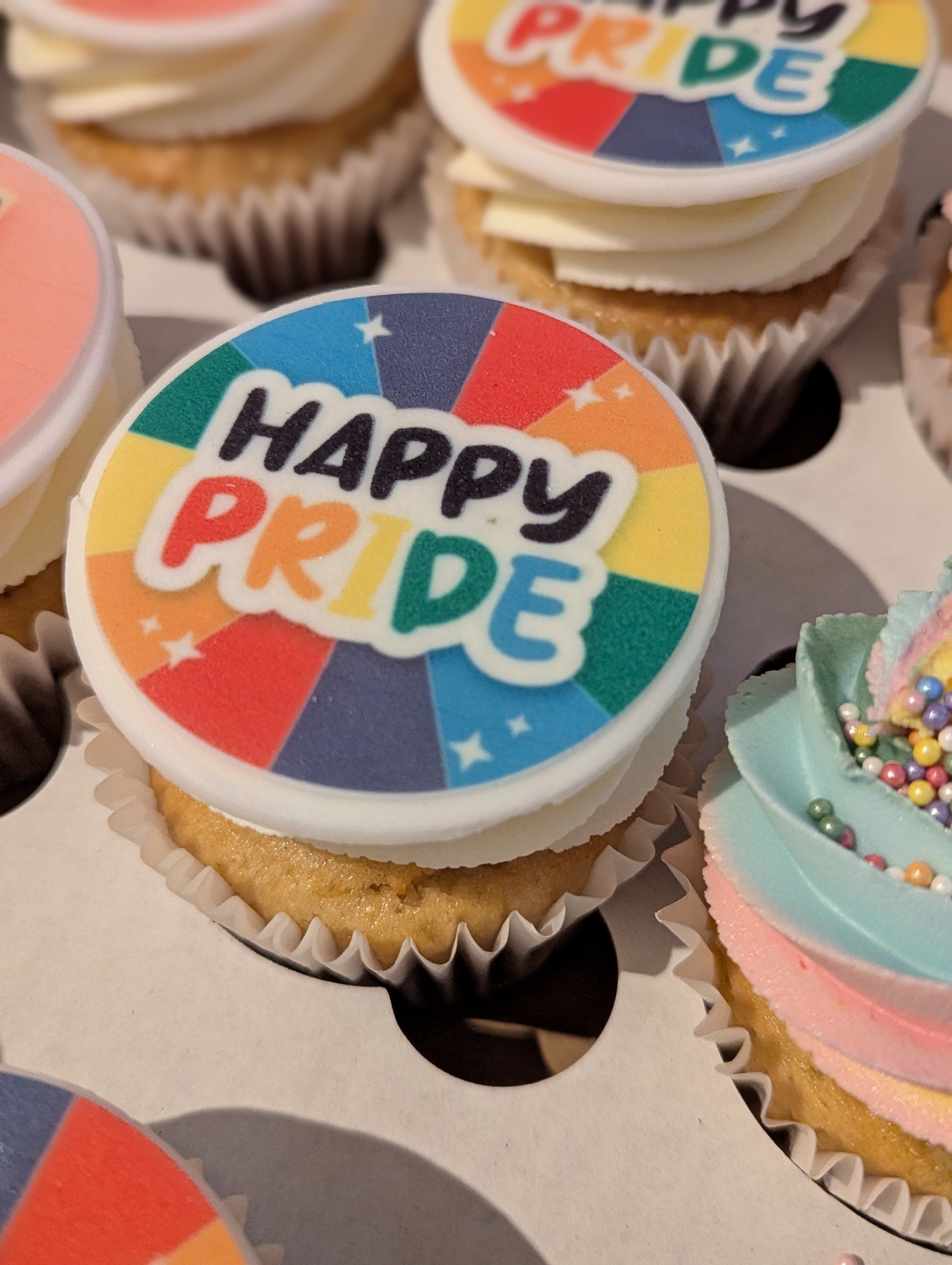 Cupcakes with 'Happy Pride' decoration in a box