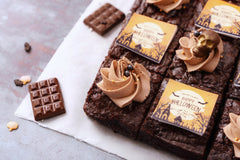 Brownies with Halloween-themed decorations and labels on a gray surface