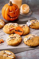 Vegan gluten-free Halloween cookies with white chocolate, pistachios, and spooky chocolate decorations 